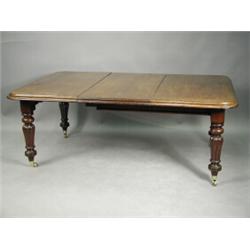 An early Victorian mahogany extending dining table with a moulded edge supported on bulbous re...