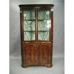 A stripped pine standing corner cabinet with four panelled doors and shaped shelves, 2.15m hig...