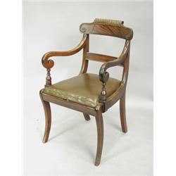 A Regency mahogany elbow chair, with a carved tablet back, on sabre legs Est. 280/320...
