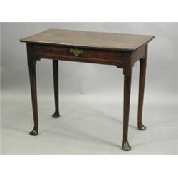 A George III mahogany side table with a single frieze drawer on turned cabriole legs and pad f...