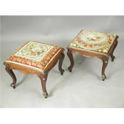 A pair of 19th century mahogany stools, each with a drop in embroidered seat on carved cabriol...