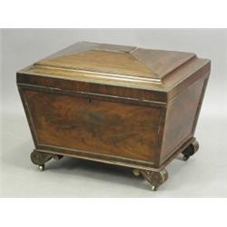 A Regency mahogany sarcophagus shaped cellarette opening to reveal a 3/4 division rack, on bra...