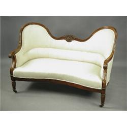 A Victorian mahogany framed two seat settee, with a concave front, on turned tapering reeded f...