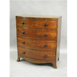 A Regency rosewood bowfront chest of four long drawers with turned handles, mother of pearl in...