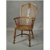 Image 1 : An early 19th century yewwood Windsor armchair, with a pierced splat, over a crinoline stretch...