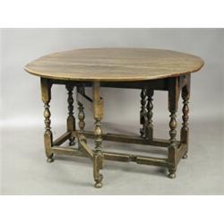 An 18th century oval oak gateleg table, with two end drawers, on turned baluster legs, 125 x 1...