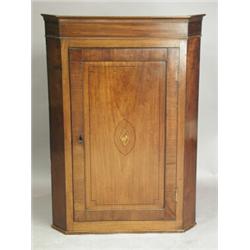 A George III mahogany hanging corner cupboard, opening to reveal three shaped shelves, 113cm<b...