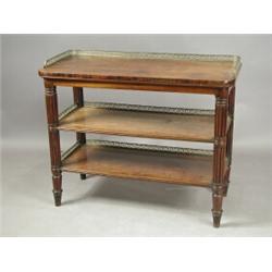 A Regency mahogany three tier buffet, each tier with a brass 3/4 gallery with pierced vitruvia...