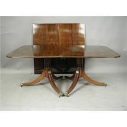 A reproduction Regency style mahogany twin pedestal dining table, the reeded top with two leav...
