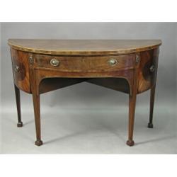 A George III strung mahogany demi lune sideboard with a central drawer and two doors on fluted...