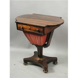 A Victorian rosewood worktable, the top with 'D' ends and a fitted drawer over a pleated silk...