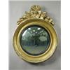 Image 1 : A Regency convex wall mirror, the moulded gilt frame with a carved wood crest, 70cm diameter<b...