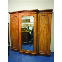 A Victorian mahogany breakfront wardrobe (one internal drawer missing), 2.14m wide x 2.09m hig...