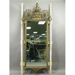 An Adam revival gilt gesso wall mirror, surmounted by an urn, a rams head, scrolling husks and...