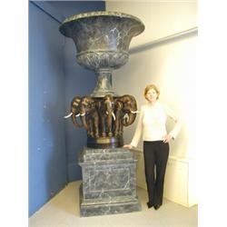 A large modern fibre glass urn with an imitation marble and bronze finish, the campana shaped...