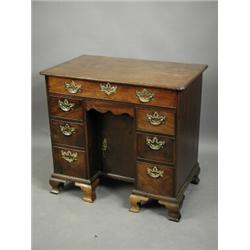 A George III mahogany kneehole desk, the moulded edge top with re entrant corners, over seven...