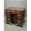 Image 1 : A George III mahogany kneehole desk, the moulded edge top with re entrant corners, over seven...