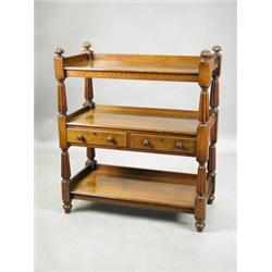A William IV mahogany three tier buffet, with two drawers to the central tier, and reeded fini...