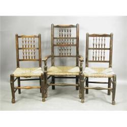 A set of six rush seated provincial ladderback chairs, comprising two carver armchairs and fou...