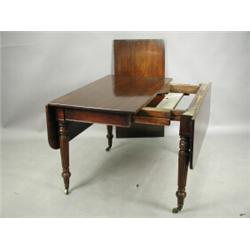 A Victorian mahogany drop leaf extending dining table with an unusual draw leaf action and a s...