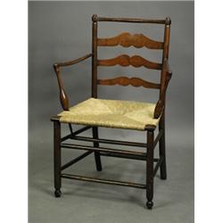 A 19th century elm ladderback country armchair with a rush seat Est. 200/300...