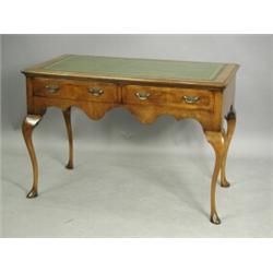 A walnut two drawer writing table on cabriole legs, 106cm wide Est. 450/650...