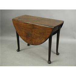 An 18th century oval mahogany drop leaf table, with turned tapering legs and pad feet, 92 x 12...