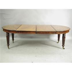 A Victorian mahogany extending dining table, with two extra leaves, supported on tapering reed...