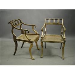 A pair of Regency style elbow chairs with gilt and painted decoration and cane seats Est. 6...