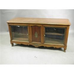 A reproduction burr wood shop counter, the front with two shallow glazed cupboards the reverse...