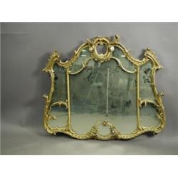 A Chippendale style carved wood and gilt overmantel mirror of cartouche shape with a single pl...