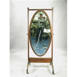 An Edwardian mahogany cheval mirror with an oval glass in a reeded frame Est. 200/400...