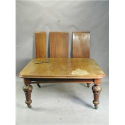 A Victorian mahogany extending dining table, with a moulded top, three extra leaves, with turn...