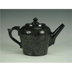 An 18th century Jackfield type teapot, with stylised decoration, (chipped), 13cm Est. 250/350...