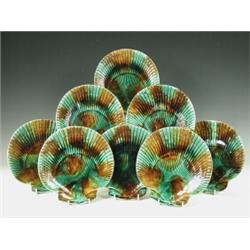 A set of eight Victorian Majolica scallop-shaped plates, one marked with an impressed heart, six...