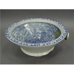 A 19th century blue and white toilet bowl printed with a classical scene, impressed rope twist ma...