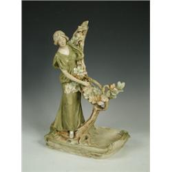 A Royal Dux figure, originally holding a frame on a tree, the base a tray with raised pink triang...