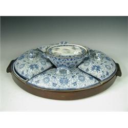 A 19th century blue and white pottery breakfast set, with four covered dishes and a central stand...