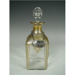 A 19th century spirit decanter with gilt decoration and a Georgian Scottish silver decanter label...