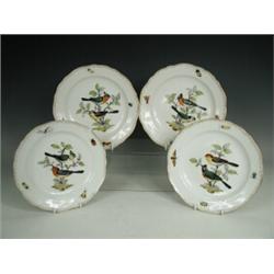 A set of four Meissen porcelain scalloped edge dessert plates, each with outside hand painted orn...