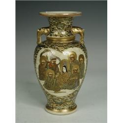 A late Meiji period Satsuma vase, decorated with seated figures within a heart shaped cartouche a...