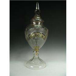 A late 19th century cut-glass whisky urn and cover. The panelled cover with a spire finial over a...