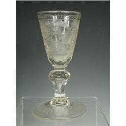An 18th century glass goblet with a wheel cut engraved bowl a facetted knop with an inverted tear...