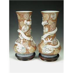 A pair of late 19th/early 20th century Oriental polychrome decorated vases with shaped cartouches...