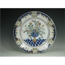A late 18th/early 19th century lead glaze polychrome charger, in Rouen style, monogrammed 'AK' ve...