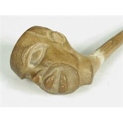 A Victorian clay pipe, the bowl modelled as a bearded negro, impressed registration mark on pipe...