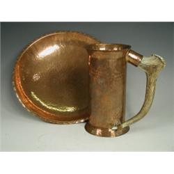 An Arts & Crafts copper beaker with a horn handle, stamped G W G, 19.5cm together with a matching...
