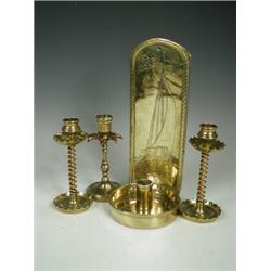 A pair of copper and brass candlesticks, another, and a brass wall sconce, engraved with a sailin...