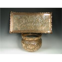 An Arts & Crafts copper tray decorated with a jardiniFre and birds, together with a copper jardin...