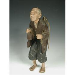A late 19th century Japanese carved wood and painted figure of an old man, circa 1880, 39cm high...